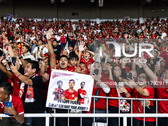 Indonesian fans cheer after the FIFA World Cup Asian 3rd Qualifier Group C match against Saudi Arabia at Gelora Bung Karno Stadium in Jakart...