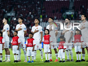 Indonesian players line up during the national anthems before the FIFA World Cup Asian 3rd Qualifier Group C match against Saudi Arabia at G...