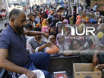 Lower-income people stand in line to buy government-subsidized food in Dhaka, Bangladesh, on November 19, 2024. (