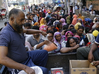 Lower-income people stand in line to buy government-subsidized food in Dhaka, Bangladesh, on November 19, 2024. (