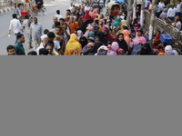 Lower-income people stand in line to buy government-subsidized food in Dhaka, Bangladesh, on November 19, 2024. (