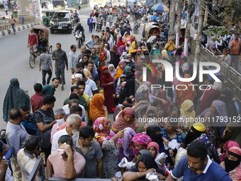 Lower-income people stand in line to buy government-subsidized food in Dhaka, Bangladesh, on November 19, 2024. (