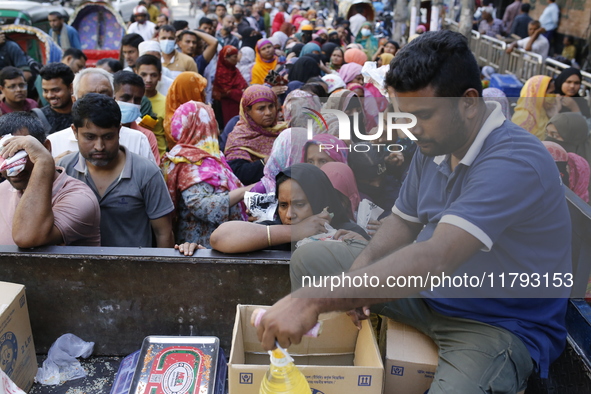 Lower-income people stand in line to buy government-subsidized food in Dhaka, Bangladesh, on November 19, 2024. 