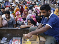 Lower-income people stand in line to buy government-subsidized food in Dhaka, Bangladesh, on November 19, 2024. (