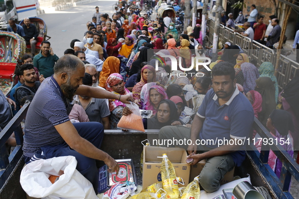 Lower-income people stand in line to buy government-subsidized food in Dhaka, Bangladesh, on November 19, 2024. 