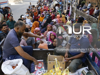 Lower-income people stand in line to buy government-subsidized food in Dhaka, Bangladesh, on November 19, 2024. (