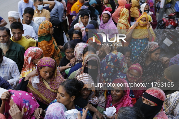 Lower-income people stand in line to buy government-subsidized food in Dhaka, Bangladesh, on November 19, 2024. 