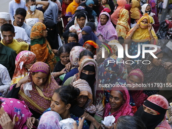 Lower-income people stand in line to buy government-subsidized food in Dhaka, Bangladesh, on November 19, 2024. (