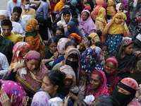 Lower-income people stand in line to buy government-subsidized food in Dhaka, Bangladesh, on November 19, 2024. (