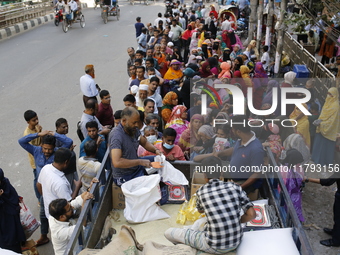 Lower-income people stand in line to buy government-subsidized food in Dhaka, Bangladesh, on November 19, 2024. (