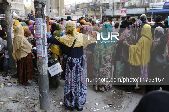 Lower-income people stand in line to buy government-subsidized food in Dhaka, Bangladesh, on November 19, 2024. 