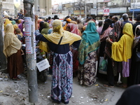 Lower-income people stand in line to buy government-subsidized food in Dhaka, Bangladesh, on November 19, 2024. (