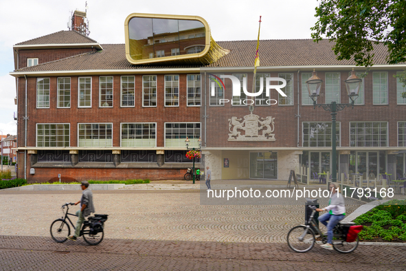 Cyclists pass by the Museum van Bommel van Dam in Venlo, Netherlands, on July 28, 2023. The museum's unique modern design complements its ro...