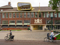 Cyclists pass by the Museum van Bommel van Dam in Venlo, Netherlands, on July 28, 2023. The museum's unique modern design complements its ro...