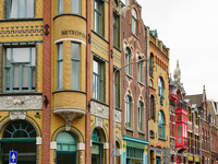 Cyclists navigate a well-maintained bike lane in Venlo, Netherlands, on July 28, 2023, passing vibrant and ornately detailed historic facade...