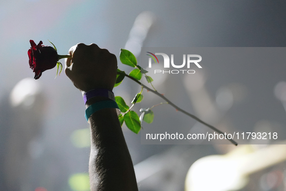 A man holds a rose during the performance of the American hardcore/grindcore band Squid Pisser at the Gwar The Stoned Age Tour at The Factor...