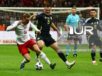 Adam Buksa and Billy Gilmour during UEFA Nations League match Poland - Scotland at National Stadium in Warsaw, Poland on November 18, 2024....