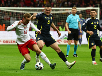 Adam Buksa and Billy Gilmour during UEFA Nations League match Poland - Scotland at National Stadium in Warsaw, Poland on November 18, 2024....