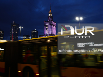 A city bus passes by as the Palace of Culture and Science is seen in Warsaw, Poland on November 18, 2024. (