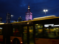 A city bus passes by as the Palace of Culture and Science is seen in Warsaw, Poland on November 18, 2024. (