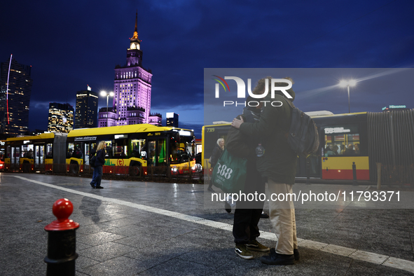 A couple hug and the Palace of Culture and Science is seen in Warsaw, Poland on November 18, 2024. 