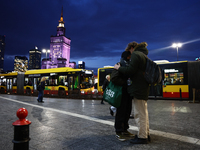 A couple hug and the Palace of Culture and Science is seen in Warsaw, Poland on November 18, 2024. (