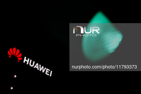 Huawei logo on the building and green traffic light are seen in Warsaw, Poland on November 18, 2024. 