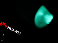 Huawei logo on the building and green traffic light are seen in Warsaw, Poland on November 18, 2024. (