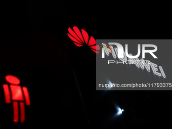 Huawei logo on the building and red traffic light are seen in Warsaw, Poland on November 18, 2024. (