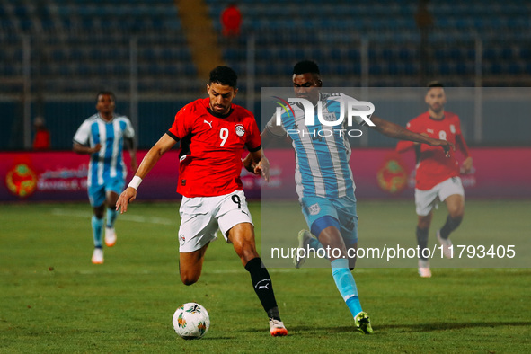 Egyptian player Taher Mohamed Taher competes against a Botswana player during the Africa Cup of Nations Qualifiers match in Cairo, Egypt, on...