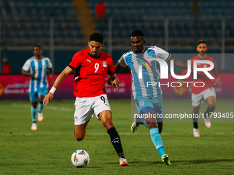 Egyptian player Taher Mohamed Taher competes against a Botswana player during the Africa Cup of Nations Qualifiers match in Cairo, Egypt, on...