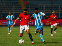 Egyptian player Taher Mohamed Taher competes against a Botswana player during the Africa Cup of Nations Qualifiers match in Cairo, Egypt, on...