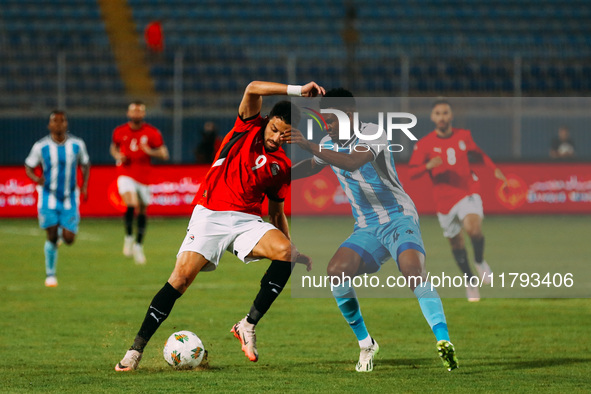 Egyptian player Taher Mohamed Taher competes against a Botswana player during the Africa Cup of Nations Qualifiers match in Cairo, Egypt, on...