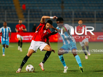 Egyptian player Taher Mohamed Taher competes against a Botswana player during the Africa Cup of Nations Qualifiers match in Cairo, Egypt, on...