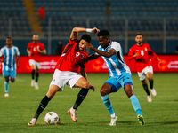 Egyptian player Taher Mohamed Taher competes against a Botswana player during the Africa Cup of Nations Qualifiers match in Cairo, Egypt, on...