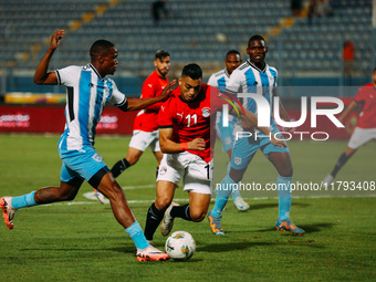 Egyptian player Mostafa Mohamed plays against a Botswana player during the Africa Cup of Nations Qualifiers match in Cairo, Egypt, on Novemb...