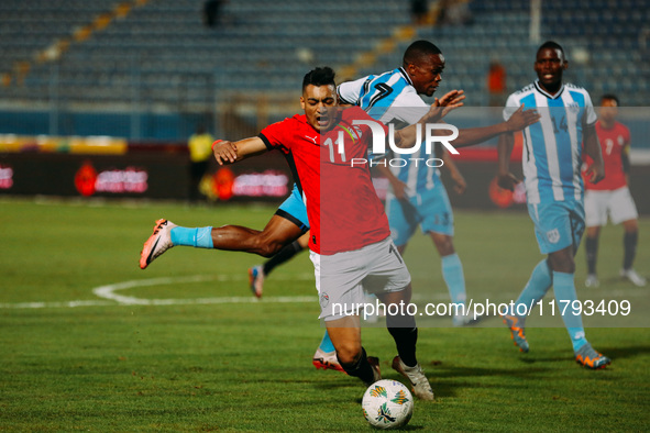 Egyptian player Mostafa Mohamed plays against a Botswana player during the Africa Cup of Nations Qualifiers match in Cairo, Egypt, on Novemb...