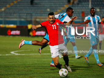 Egyptian player Mostafa Mohamed plays against a Botswana player during the Africa Cup of Nations Qualifiers match in Cairo, Egypt, on Novemb...