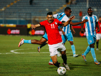 Egyptian player Mostafa Mohamed plays against a Botswana player during the Africa Cup of Nations Qualifiers match in Cairo, Egypt, on Novemb...