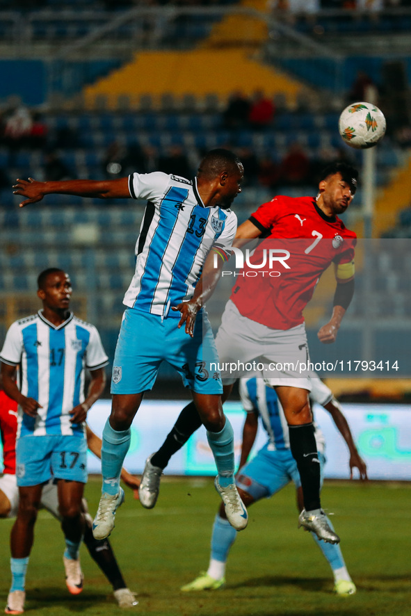 Egyptian player Mahmoud Trezeguet competes against a Botswana player during the Africa Cup of Nations Qualifiers match between Egypt and Bot...