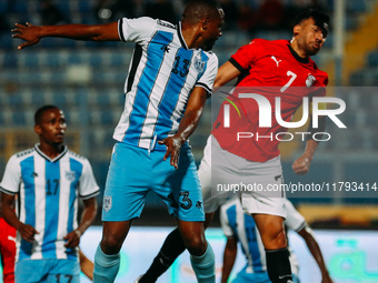 Egyptian player Mahmoud Trezeguet competes against a Botswana player during the Africa Cup of Nations Qualifiers match between Egypt and Bot...