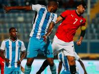 Egyptian player Mahmoud Trezeguet competes against a Botswana player during the Africa Cup of Nations Qualifiers match between Egypt and Bot...