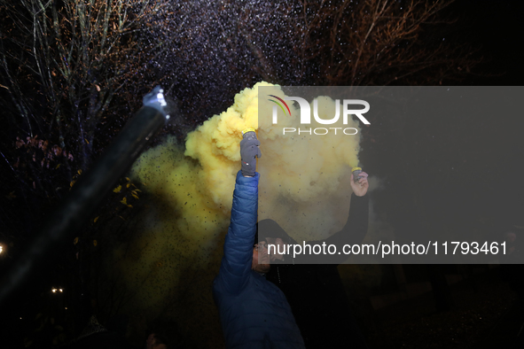 Smoke flares and black confetti are fired during a protest organized on the 1000th day of the war in Ukraine in front of the Embassy of the...