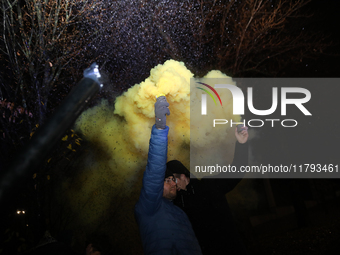 Smoke flares and black confetti are fired during a protest organized on the 1000th day of the war in Ukraine in front of the Embassy of the...