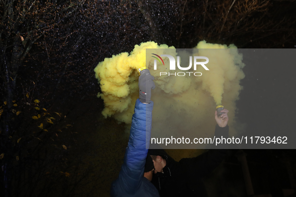 Smoke flares and black confetti are fired during a protest organized on the 1000th day of the war in Ukraine in front of the Embassy of the...