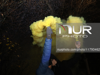 Smoke flares and black confetti are fired during a protest organized on the 1000th day of the war in Ukraine in front of the Embassy of the...