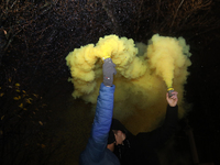 Smoke flares and black confetti are fired during a protest organized on the 1000th day of the war in Ukraine in front of the Embassy of the...