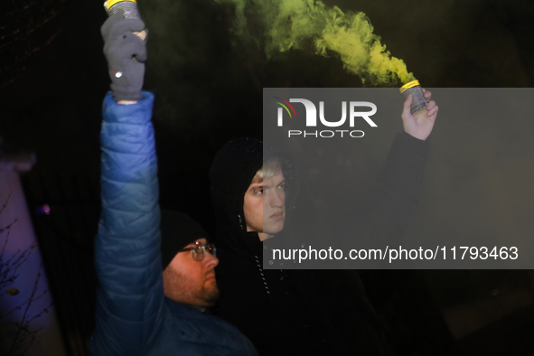 Smoke flares and black confetti are fired during a protest organized on the 1000th day of the war in Ukraine in front of the Embassy of the...