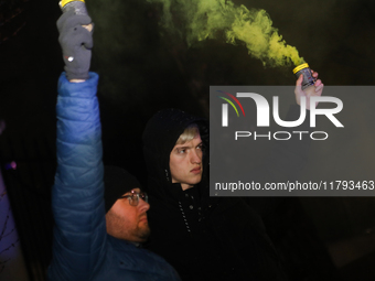 Smoke flares and black confetti are fired during a protest organized on the 1000th day of the war in Ukraine in front of the Embassy of the...