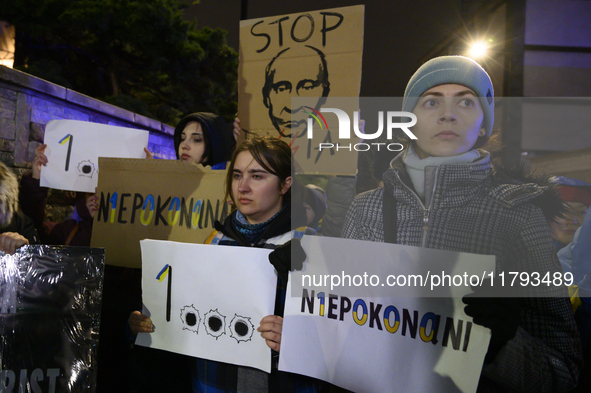 People hold placards and signs that read ''Stop Russia'' and ''Unbeatable'' as they rally on the 1000th day of Russian aggression on Ukraine...